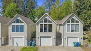A row of three single-story houses with attached garages, each with a front porch and a small front yard. - Modern 1BR Retreat with Garage and Yard (Coeur d'Alene)