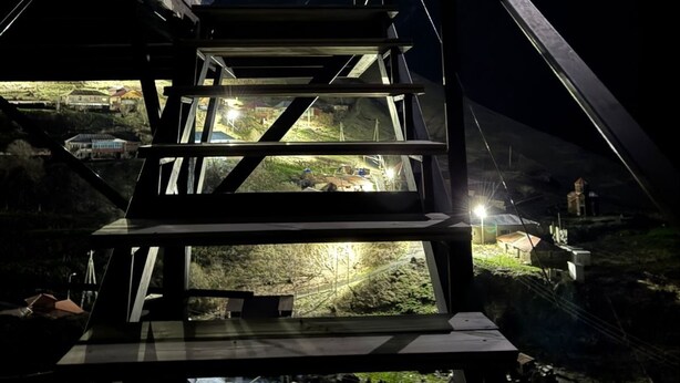 A staircase leading to a building with a mountain view at night. - Gorgeous 1-bedroom cabin in peaceful Juta for a cozy escape (Juta)