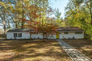 A single-story house with a front yard, a pathway leading to the front door, and a mailbox.