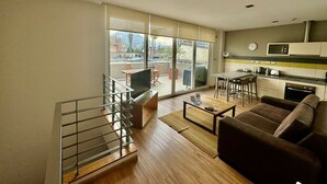 A modern apartment with a balcony, a dining area, a kitchen, and a living room. - Beautiful superior duplex apartment (Santiago)