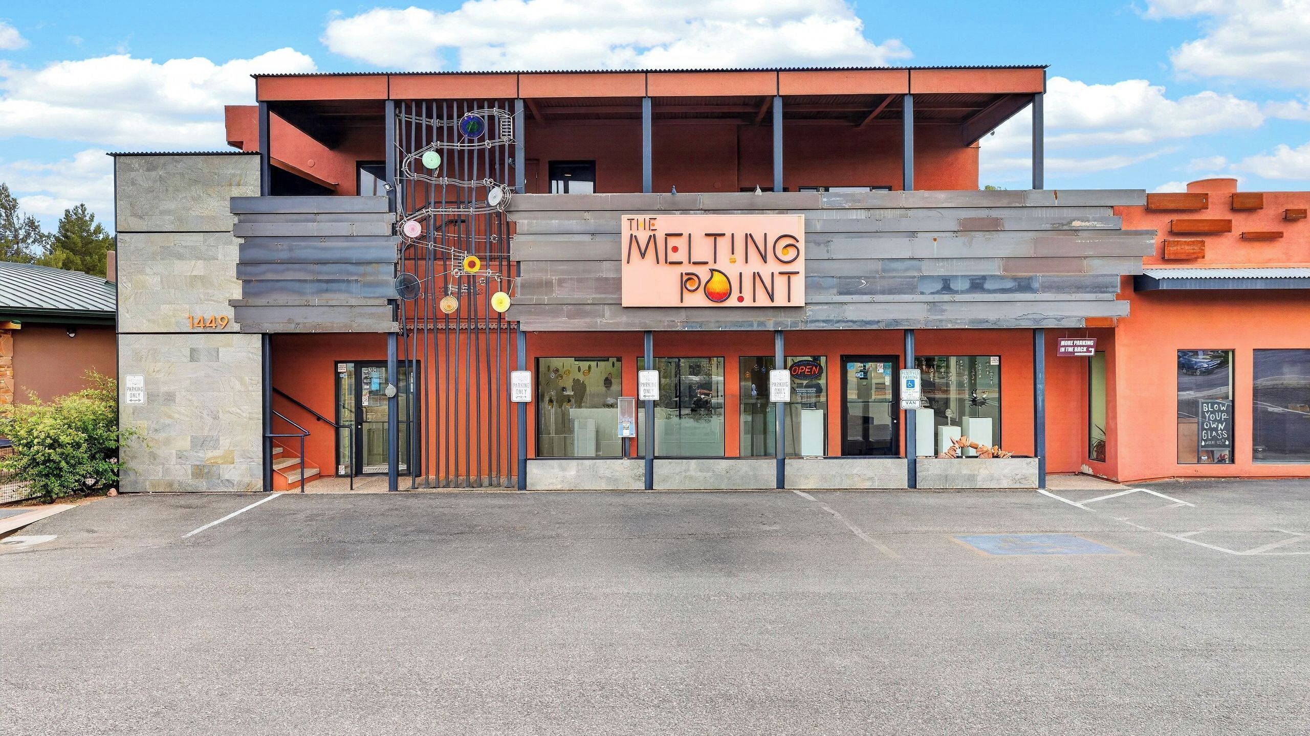 A modern building with a sign reading 'The Melting Point.'