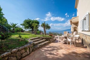 A patio with outdoor furniture, a stone staircase, and a view of the sea. - Villa Vesuvius Skyview With Amazing Pool & Terrace (Sorrento)