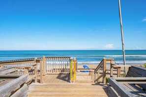 A wooden boardwalk leading to a beach with a sign indicating a scenic route. - The Last Mango, Dog Friendly, Pool & Hot Tub (Southern Shores)