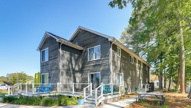 A two-story house with a porch, a picnic table, and a small garden. - 2 Mi to Bethany Beach: Duplex w/ Private Deck (Bethany Beach)