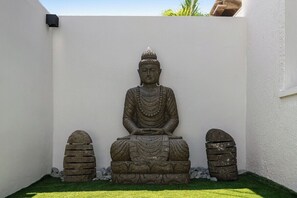 A stone Buddha statue in a garden setting. - Villa Bali: Private Pool | 2 Min Walk to Beach (San Juan)