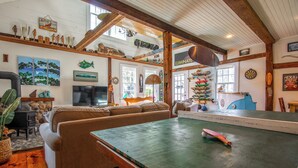 A cozy living room with a pool table, sofas, and a stone fireplace. - Ping-Pong & Fire Pit! Renovated Marshfield Cottage (Marshfield)
