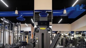 A gym with various exercise machines, a bench press, and a squat rack. - Luxury Cabo Escapes Suites, Villas & Elevated Experiences by Chez Tandrie (San José del Cabo)
