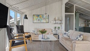 A spacious living area with a high ceiling, a sofa set, a coffee table, and a painting on the wall. - "Sote" - 330m from the sea by Interhome (Otterup)