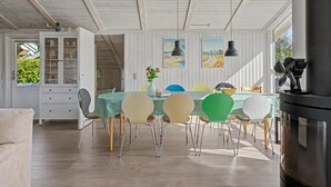 A dining area with a table, chairs, and a stove. - "Sote" - 330m from the sea by Interhome (Otterup)