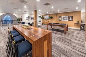 A modern lounge area with a pool table, bar seating, and framed artwork on the walls. - Cozy 2-bd apt in charming Los Angeles with AC, gym, pool, tennis !!! text !!!!!! (Los Angeles)