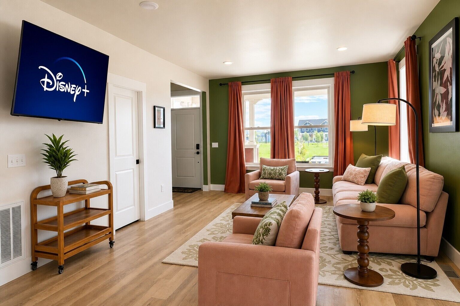 A living room with a flat-screen TV displaying the Disney+ logo, a sofa set, a coffee table, and a potted plant.