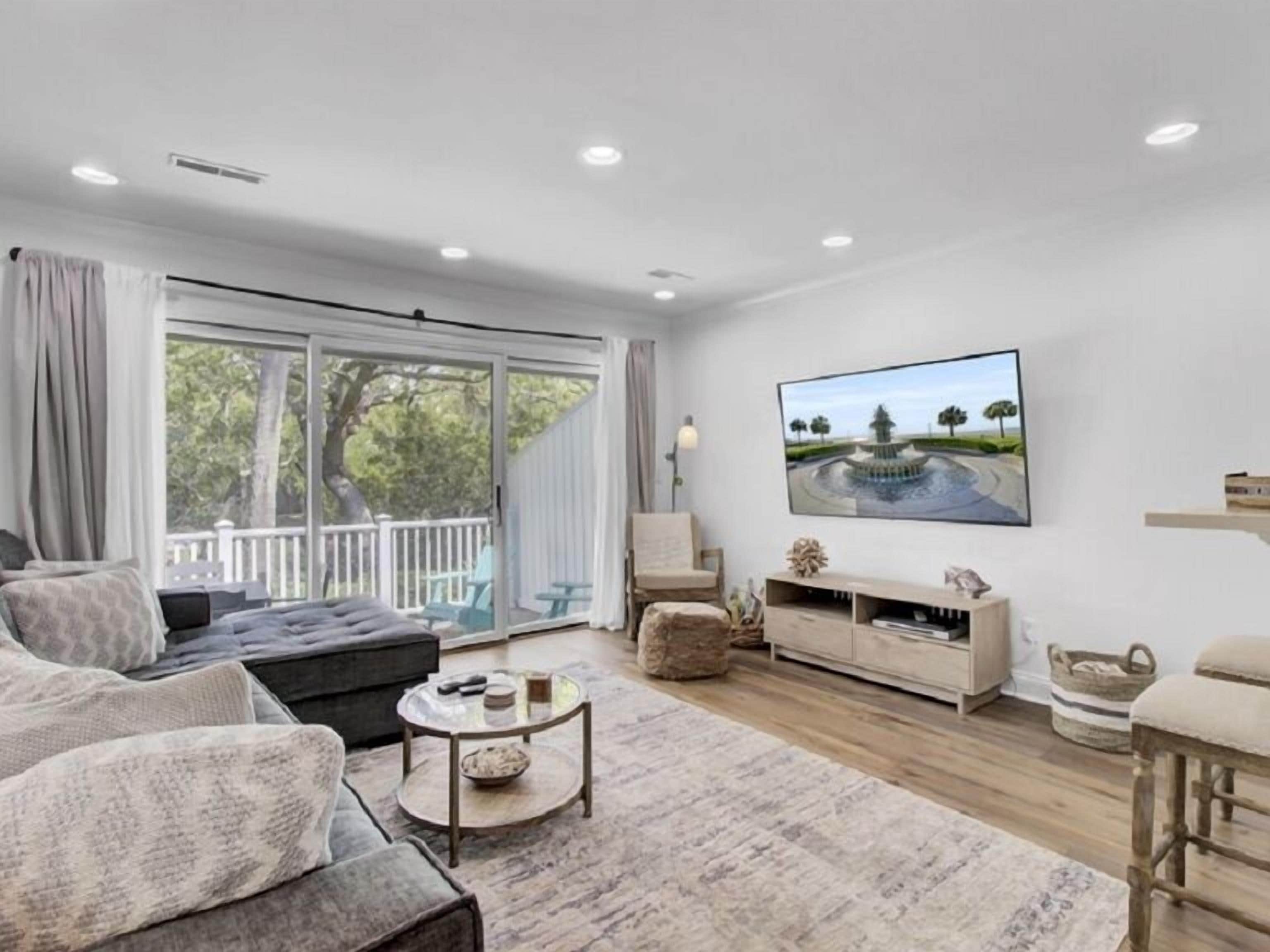 A modern living room with a sofa, coffee table, and TV.