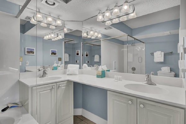 A bathroom with two sinks, a large mirror, and overhead lighting. - Wild Dunes Vacation Condos 3&4 Bedrooms (Isle of Palms)