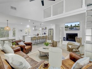 A spacious living area with a sofa set, a coffee table, and wicker chairs. - Wild Dunes Vaction Homes 3&4 Bedrooms (Isle of Palms)