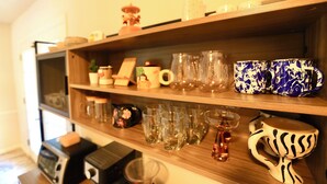 A shelf with various glassware and ceramic items. - Family-Friendly Covington Escape w/ Fenced Backyard, Full Kitchen & Coffee Bar (Covington)