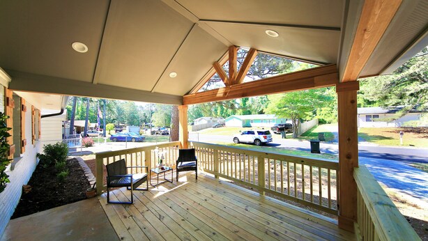 A wooden deck with a railing, a bench, and a view of a street with parked cars and houses. - Family-Friendly Covington Escape w/ Fenced Backyard, Full Kitchen & Coffee Bar (Covington)