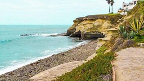 A coastal property with a stone pathway, a cliffside, and a view of the ocean. - Wonderful 3-bedroom house in Las Gaviotas perfect for your getaway (Las Gaviotas)