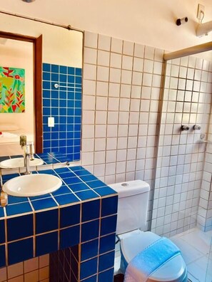 A bathroom with a sink, toilet, and shower.