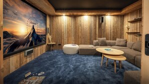Un cuarto acogedor con un amplio mural en la pared, un sofá modular, una mesa de centro redonda y una mesita auxiliar.