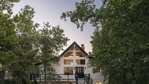 A two-story house with a gabled roof, a front porch, and a staircase leading to the entrance. - West Shore Waterview, (walk to lake & North Bay!) (Lake Arrowhead)