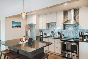 Kitchen, steel fridge and range hood - Pipes Canyon Lookout · Hot Tub, Cowboy Tub, Views (Yucca Valley)