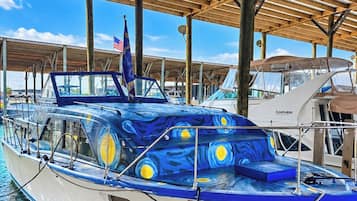 A boat docked under a covered area with a clear sky.