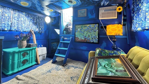 A room with a blue and yellow color scheme, a ladder, a framed picture, and a lamp. - Sleep in a Van Gogh painting! A floating tribute to the art of Vincent. (League City)