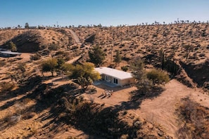 Aerial view of the home among the hills - Pipes Canyon Retreat · 2 Homes, 10 Acres, Hot Tubs (Yucca Valley)