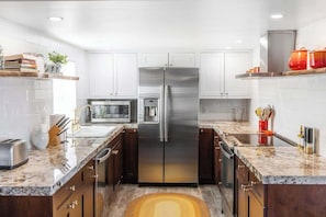 Kitchen with stainless appliances and open shelves - Pipes Canyon Retreat · 2 Homes, 10 Acres, Hot Tubs (Yucca Valley)