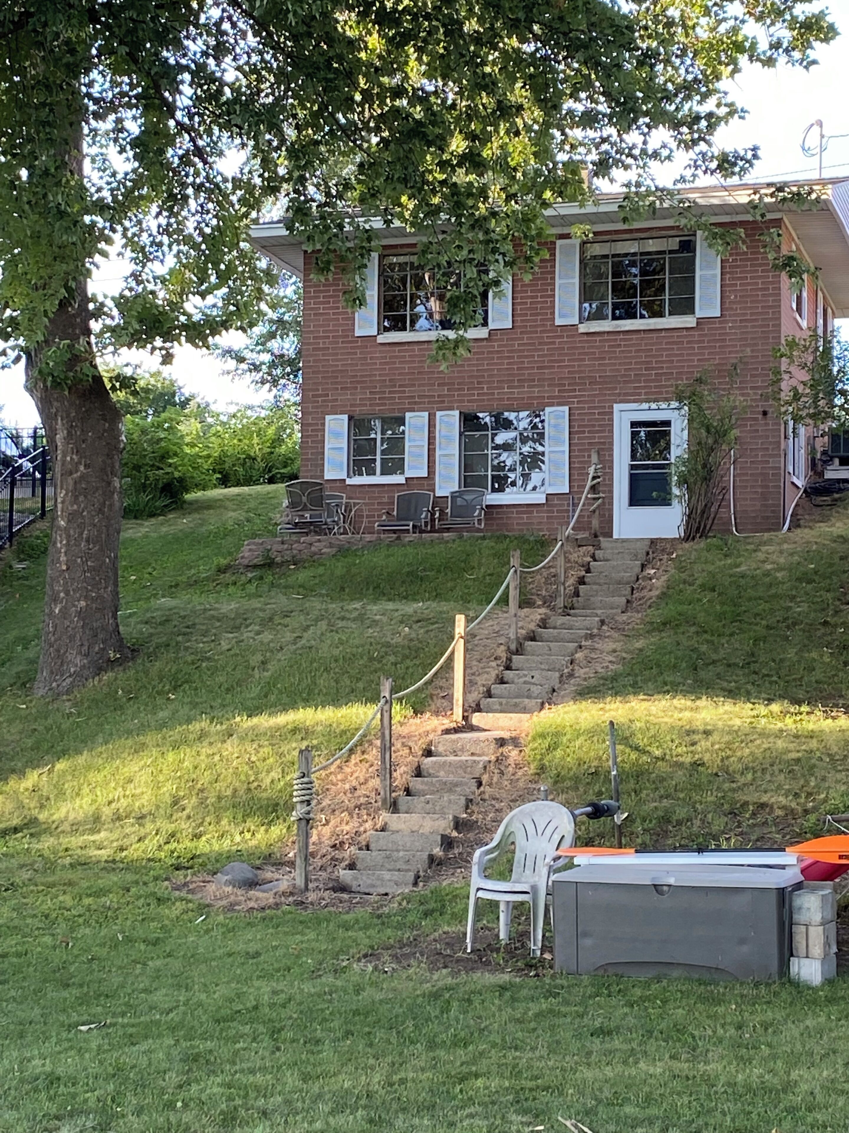 A two-story brick building with a staircase leading to the entrance.