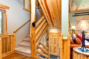 A wooden staircase with a carpeted landing, a wooden door, and a lamp on a table. - KBM Resorts | Timber Wolf Lodge | Walk to Canyons Cabriolet, Fireplace, BBQ, Aspens and Creek, Parking! TWL-12c (Park City)