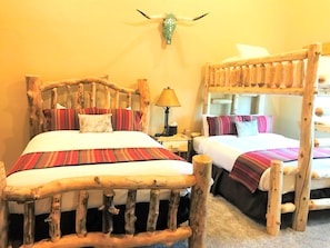 A rustic room with two wooden beds, a lamp, and a decorative skull on the wall. - KBM Resorts | Timber Wolf Lodge | Walk to Canyons Cabriolet, Fireplace, BBQ, Aspens and Creek, Parking! TWL-12c (Park City)