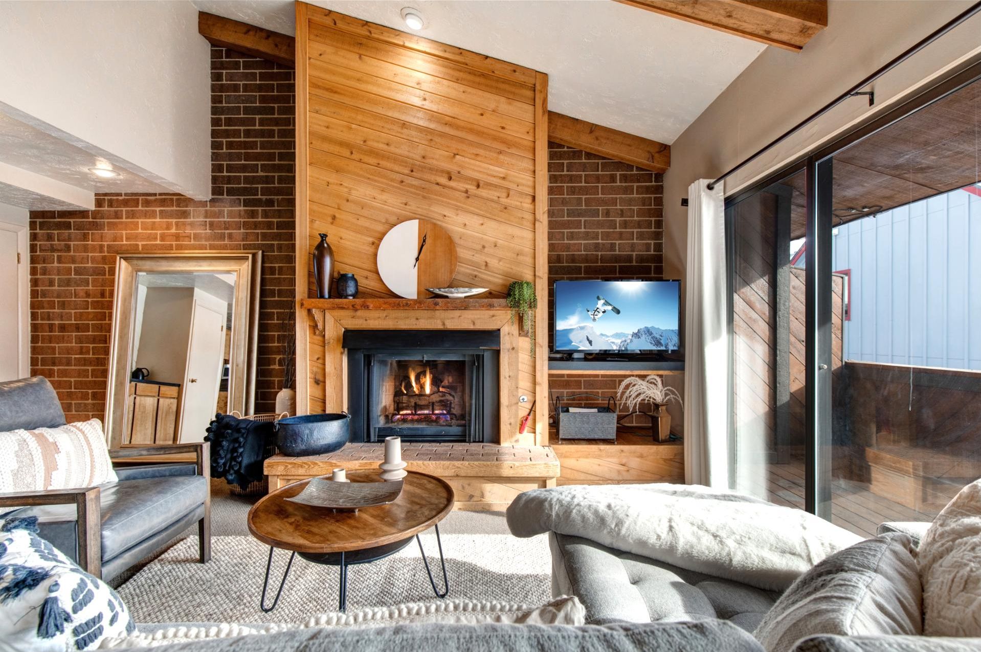 A cozy living room with a fireplace, a television, and comfortable seating.