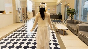 A hotel lobby with a checkered floor, a reception desk, a sofa, and a coffee table. - Gangneung Top Ocean (Gangneung)