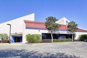 A building with a sign reading 'TOPS RACQUET CLUB' and a parking lot in front. - Spacious Coastal Escape for Family Getaways (Miramar Beach)