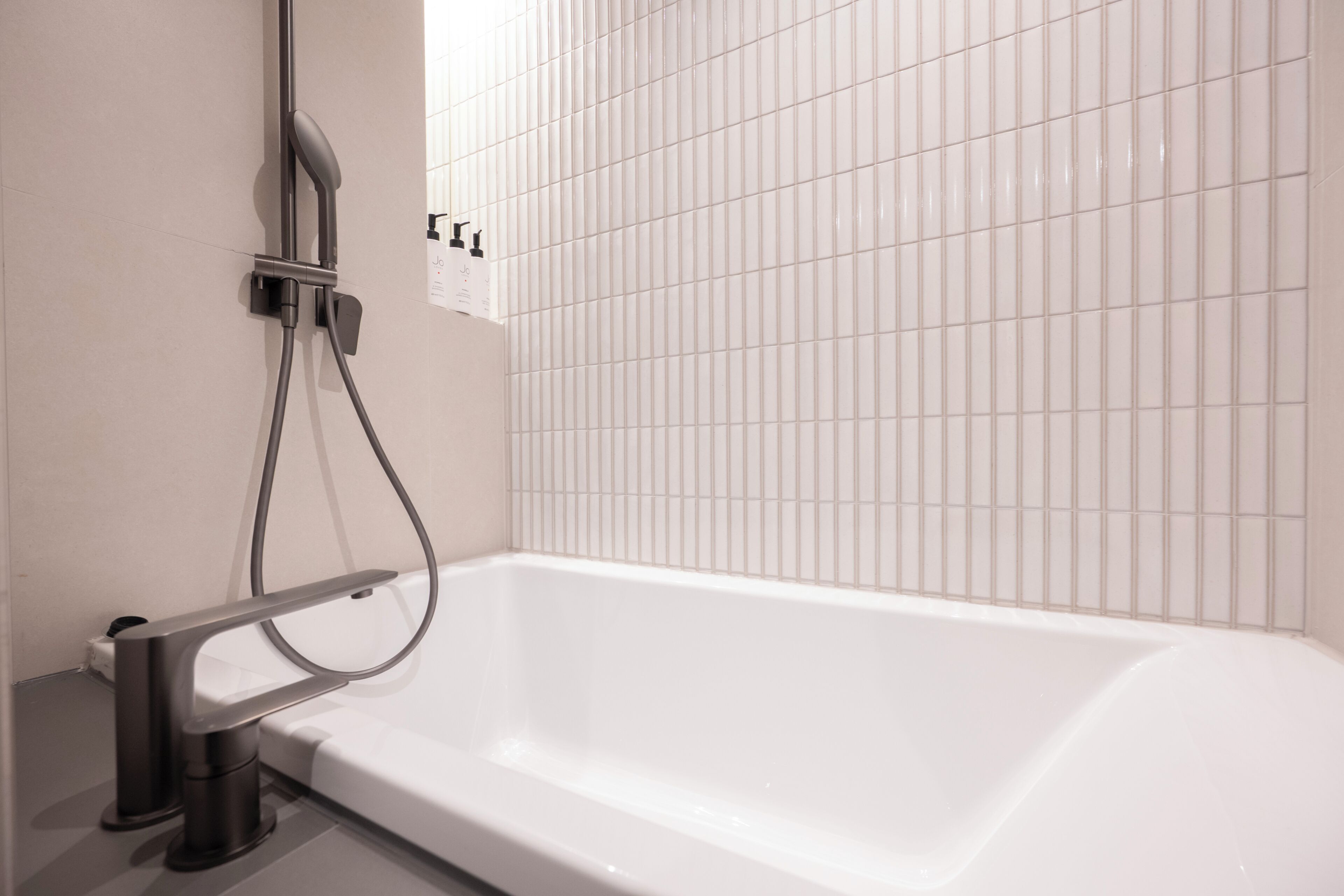 Deluxe Double Bathtub | Bathroom | Hair dryer, slippers, bidet, towels