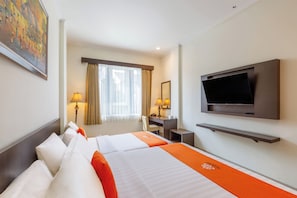 A hotel room with a bed, a desk, a chair, a television, and a window with curtains. - Alqueby Hotel Bandung (Bandung)