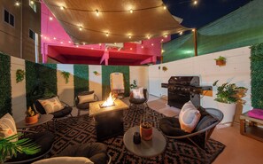 A patio area with a fire pit, seating, a grill, and decorative lights. - 10 Minutes to World Cup - Hot Tub - Fire Pit -Parking - Sleeps 6 (Hawthorne)