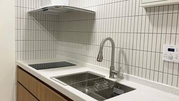 Fridge, electric kettle, dining tables