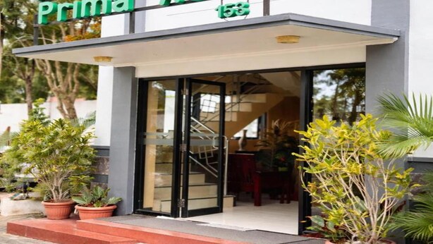 A hotel entrance with a sign reading 'Hotel Prima Asri' and a staircase leading to the door. - Hotel Prima Asri 153 (Batu)