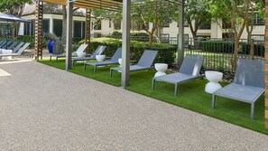 A patio area with outdoor seating and a pergola structure.