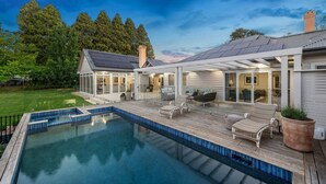 A modern house with a swimming pool, patio furniture, and a covered outdoor area. - “Southern Highlands Estate”, Private Rural Oasis. (Sutton Forest)