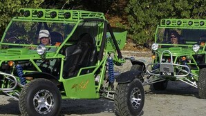 Two green off-road vehicles with seats and a steering wheel, parked on a dirt surface. - Vigie Beach Suite 1 (Castries)