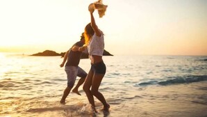 Two people walking on a beach at sunset. - Vigie Beach Suite 1 (Castries)