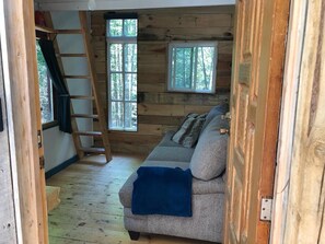 Living area - Cozy off grid retreat overlooking forest and wetlands with sauna and trails. (Arden)