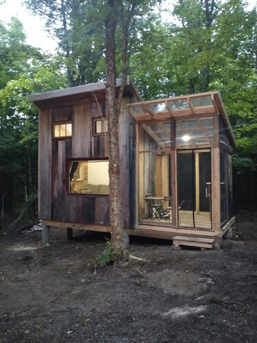 Cozy off grid retreat overlooking forest and wetlands with sauna and trails.