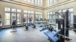 A gym with treadmills, weight machines, and benches. - Top-Floor Luxury Retreat, King Bed, Full Kitchen, Private Balcony (Frisco)