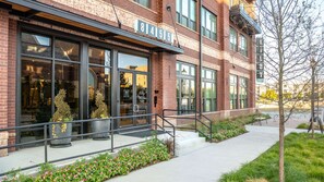 A brick building with large windows and a sign that reads 'Hilby.'