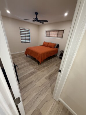 A bedroom with a bed, a ceiling fan, and a window with blinds. - Casa on 18th-Spacious 3 Bed/2Bath - Central Tucson (Tucson)