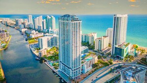 A high-rise hotel with a pool, located near a waterfront. - Luxury Beach Condo • Stunning Views (Hollywood)